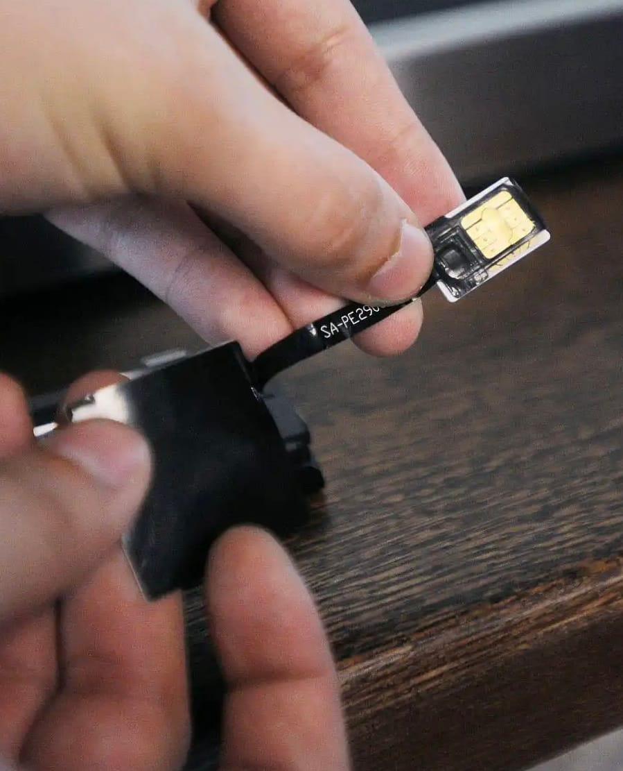 Hand holding SIM adapter with chip