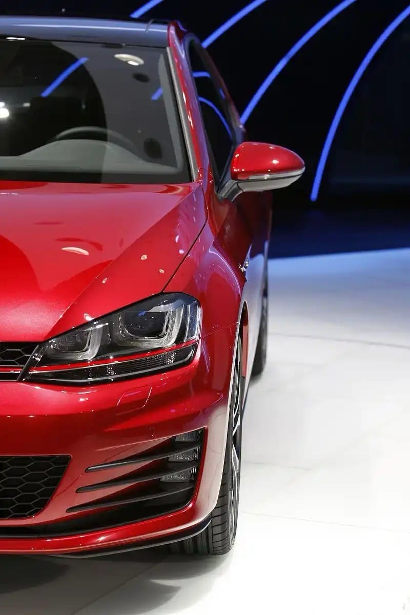 Front view of a red Volkswagen car showcasing LED headlight and sleek design