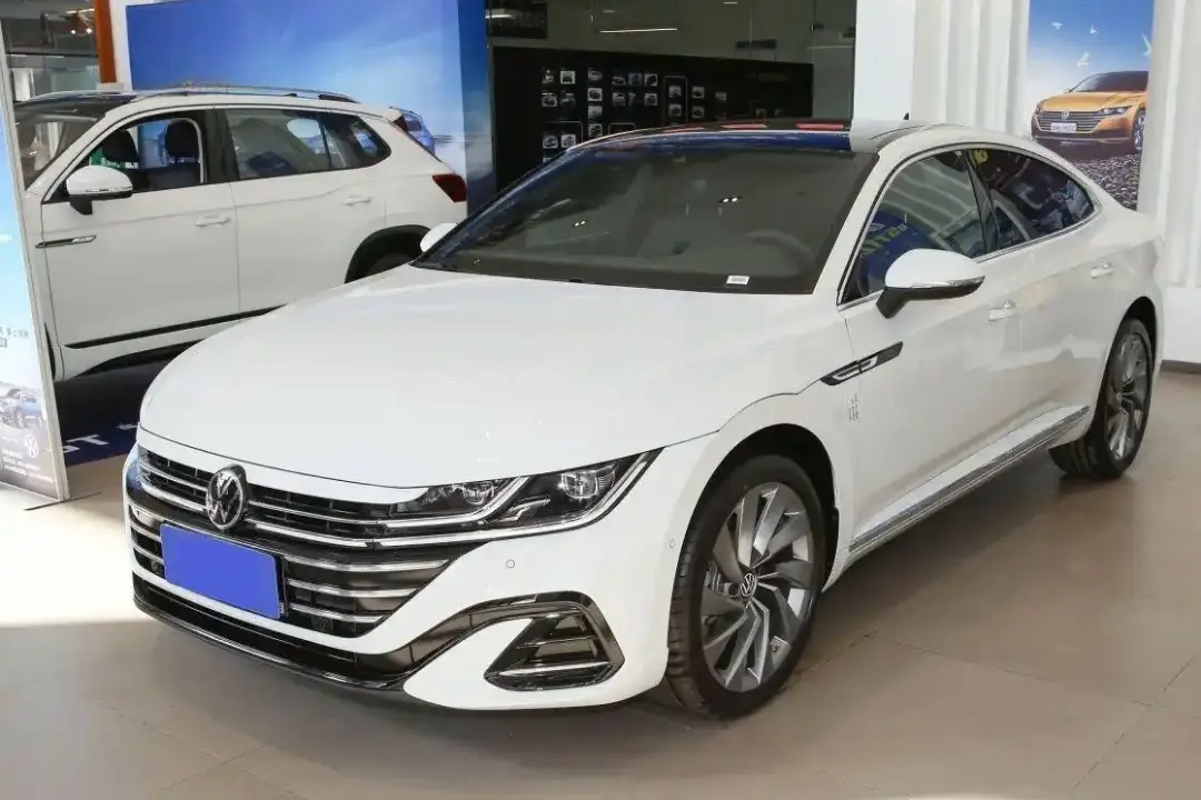 White Volkswagen Arteon sedan on showroom display with modern design