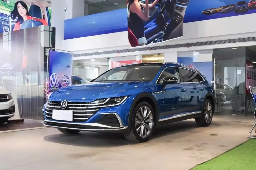 A blue Volkswagen Arteon is displayed in a showroom