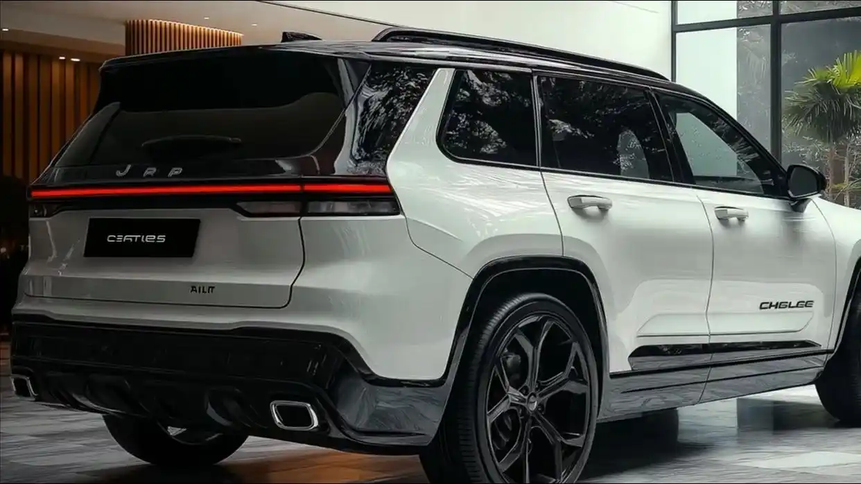 A rear three-quarters view of the 2025 Jeep Cherokee shows off its LED through-type taillights, hidden exhaust outlets, and tough metal skid guard