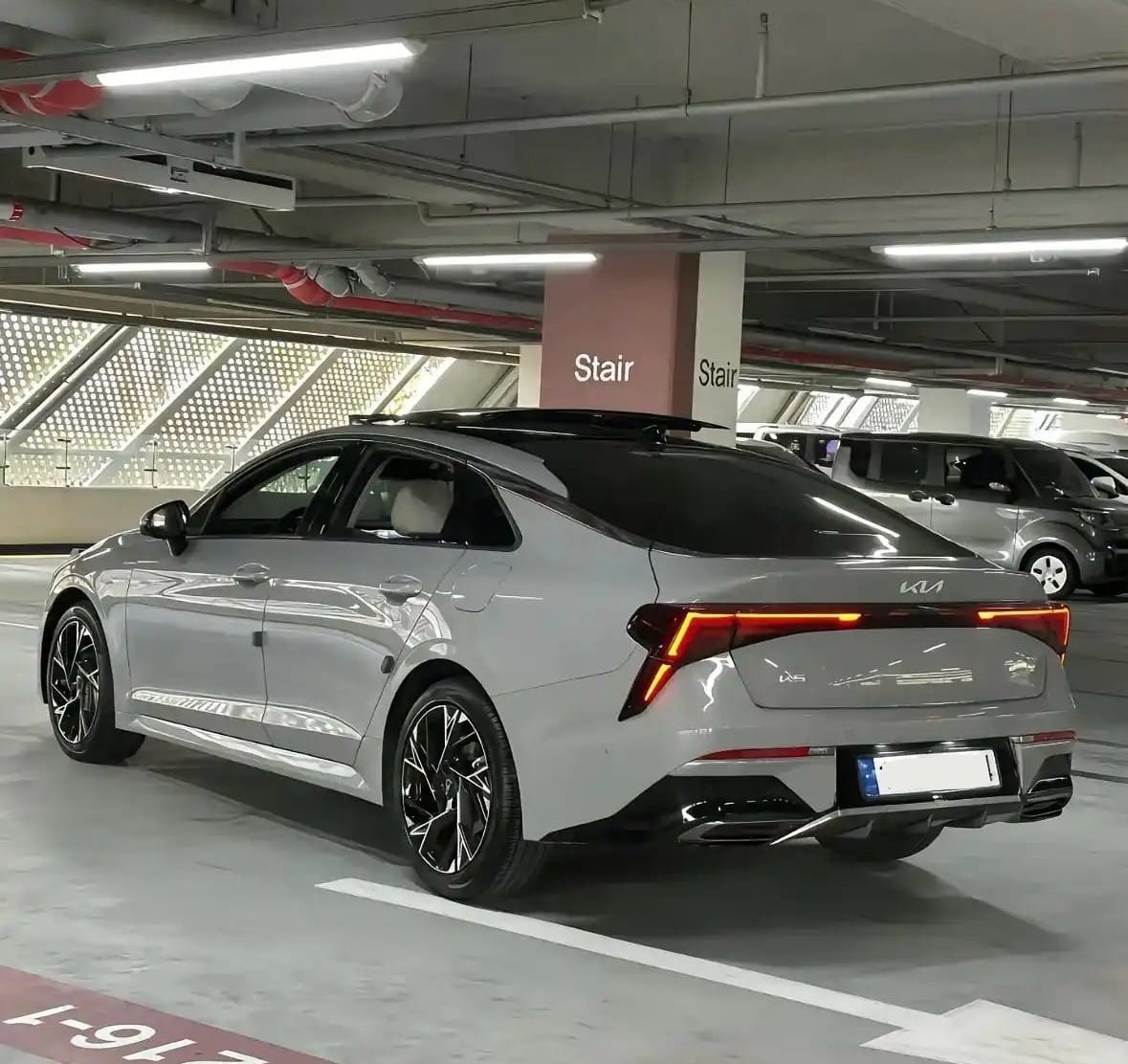 Back view of Kia K5 in parking garage
