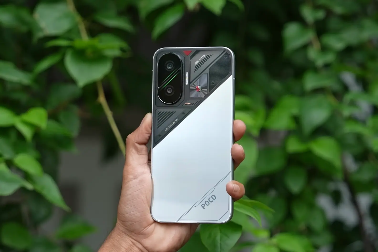 Hand holding Poco F7 with stylish rear camera design