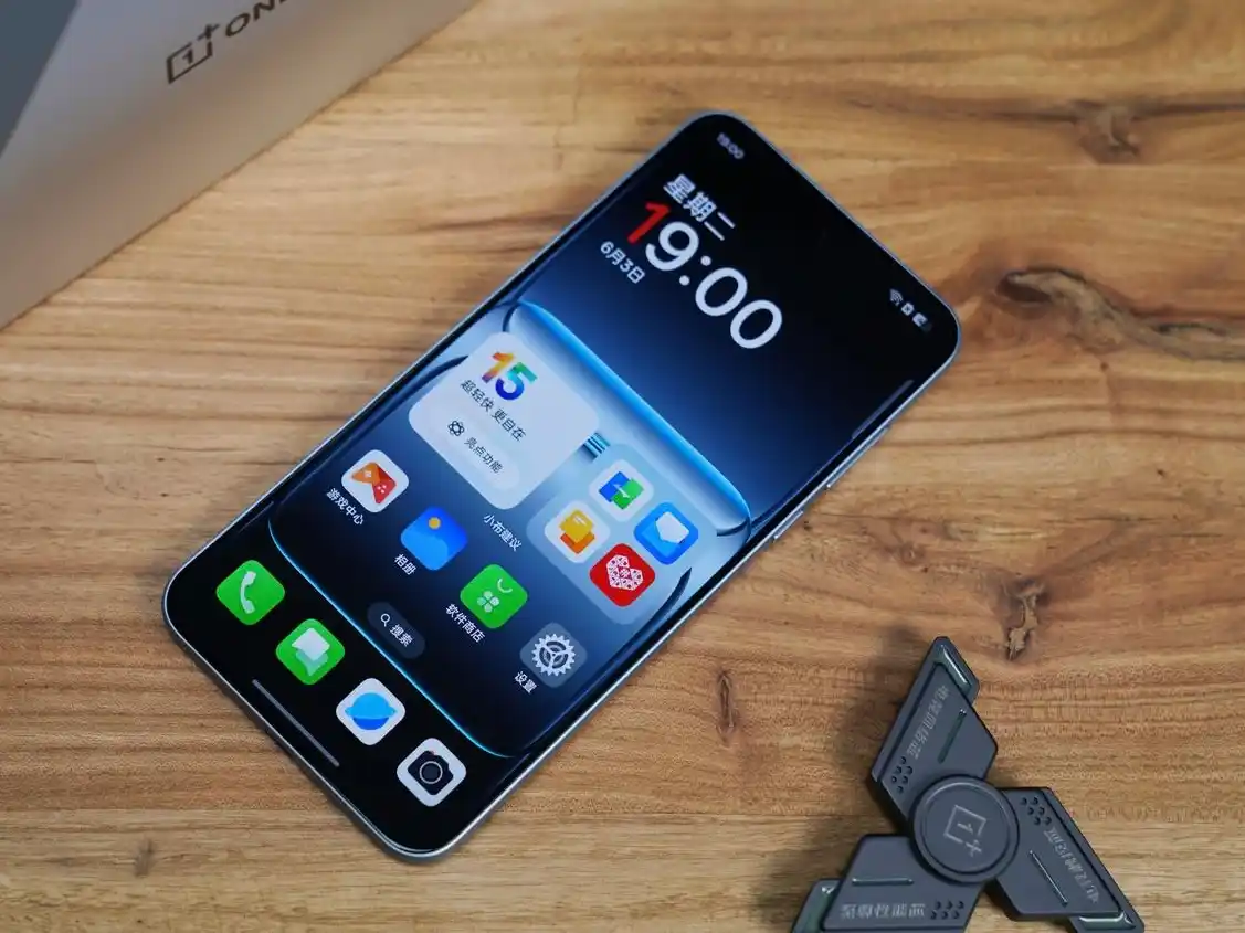 OnePlus Ace 5 smartphone on wooden table with fidget spinner