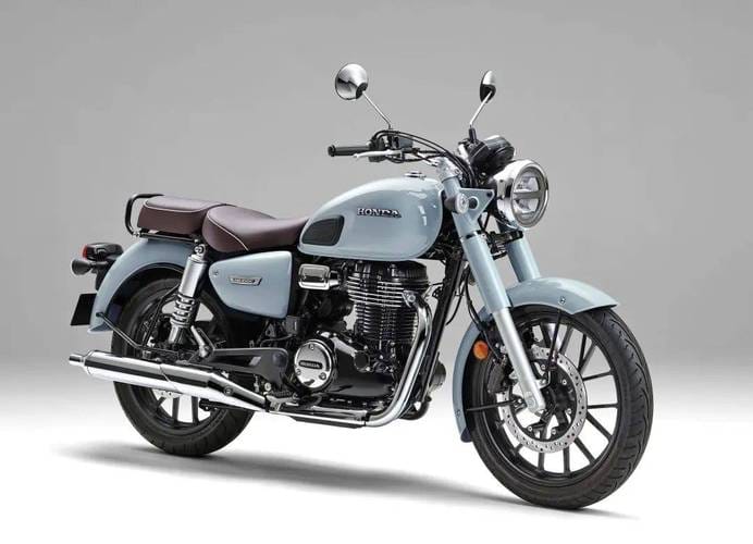 Light blue Honda CB350 cruiser motorcycle with brown leather seat