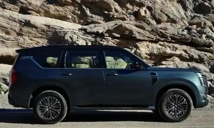 Side profile of the Nissan Patrol against a rocky backdrop