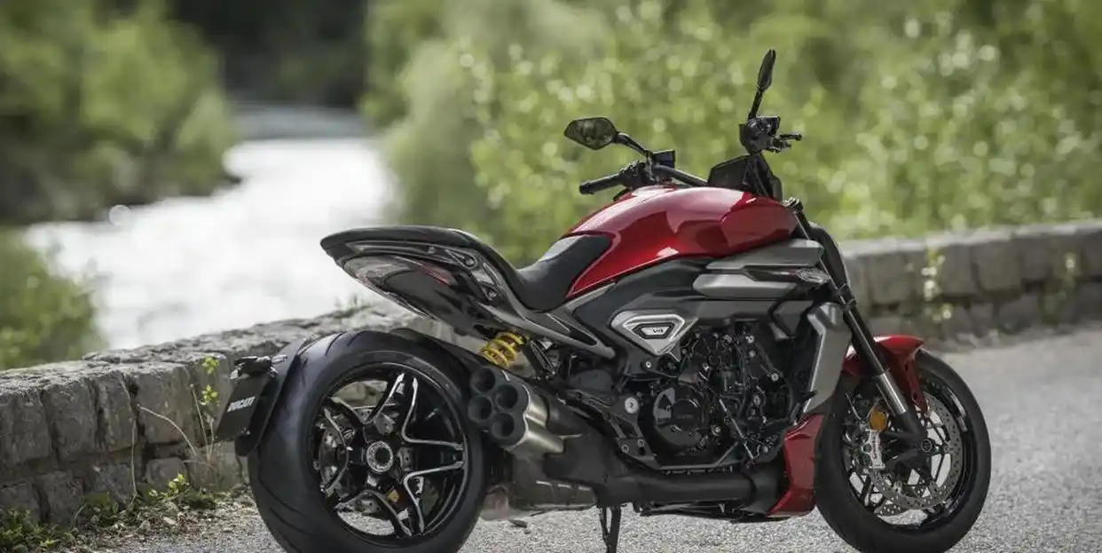 Sleek red Ducati Diavel by a nature trail