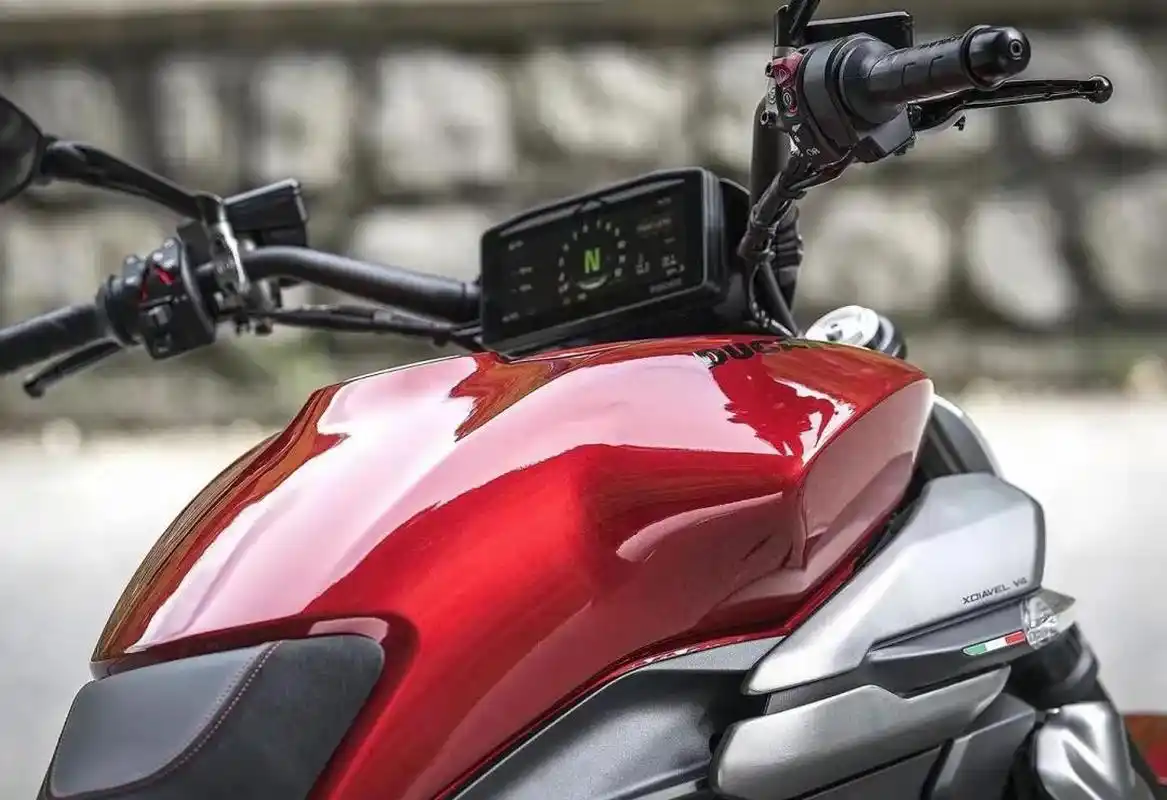 Close-up of a shiny red Ducati motorcycle fuel tank