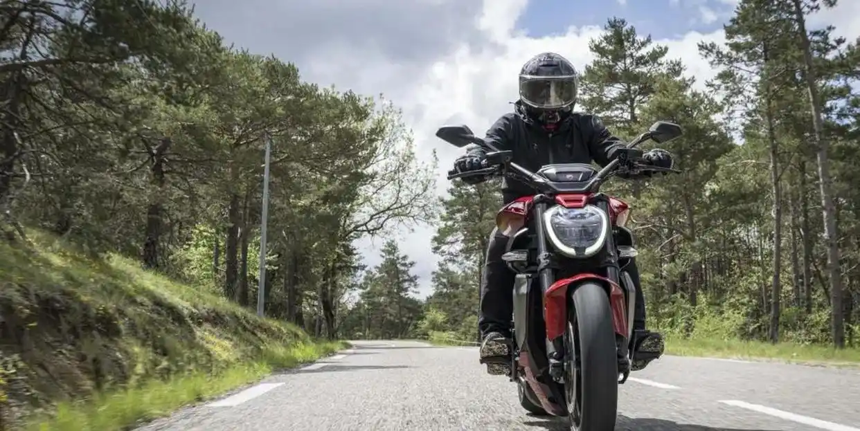 Red Ducati and rider on an open road