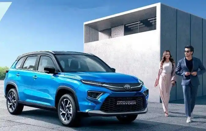 Toyota Urban Cruiser Hyryder in blue with couple nearby