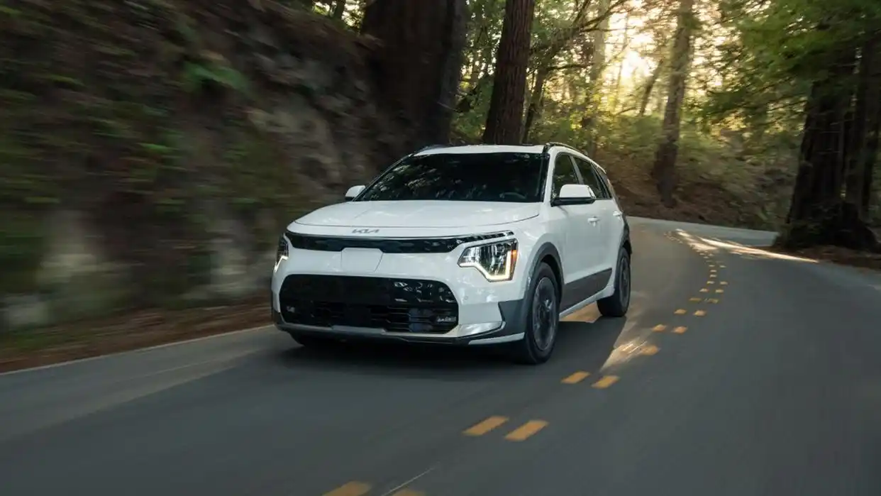 2025 Kia Niro EV driving through forest road