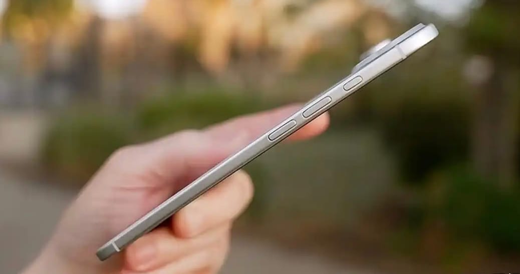 Hand holding thin iPhone 17 Air with side buttons visible