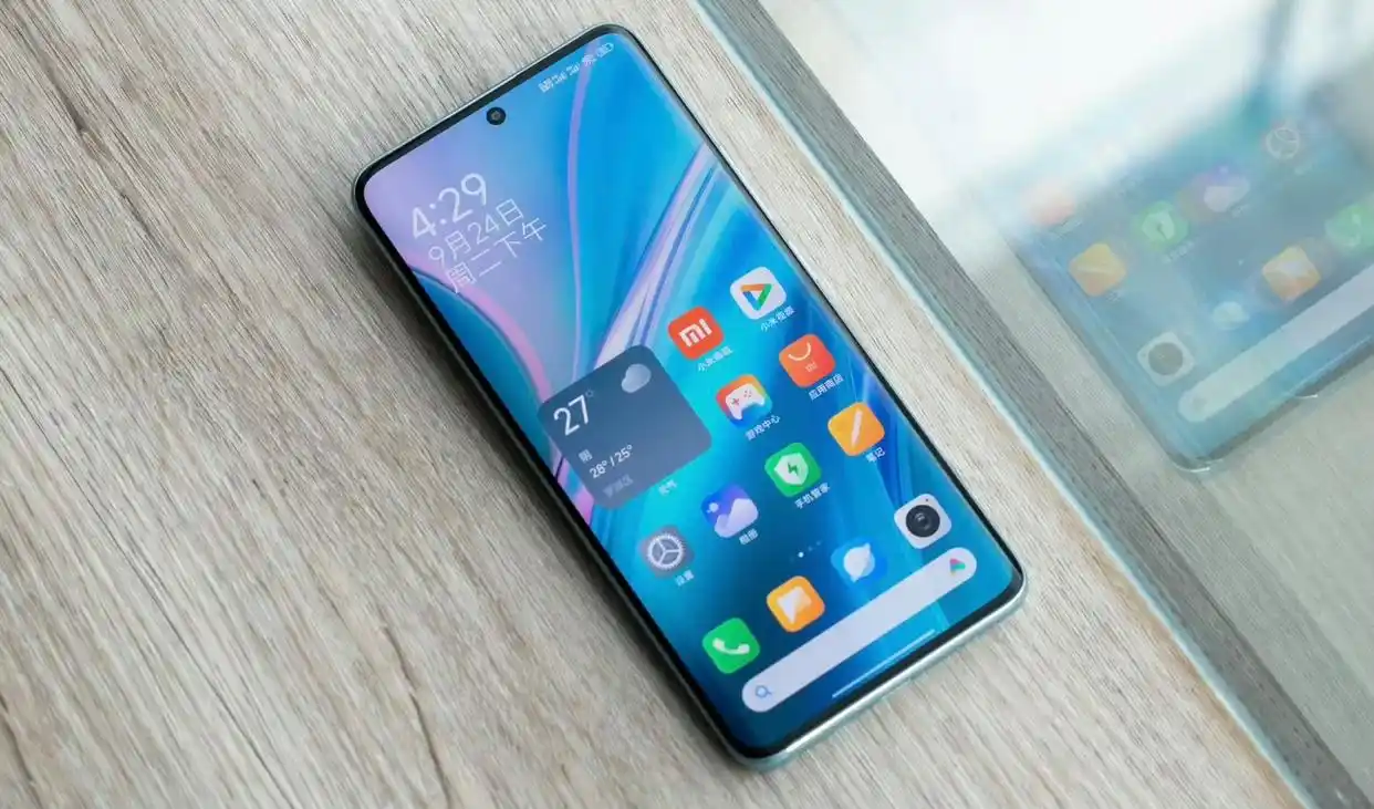 Redmi Note 14 Pro plus displaying home screen on table.