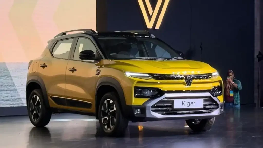 The 2025 Renault Kiger Facelift, a yellow compact SUV, is showcased on a stage during its official launch event.