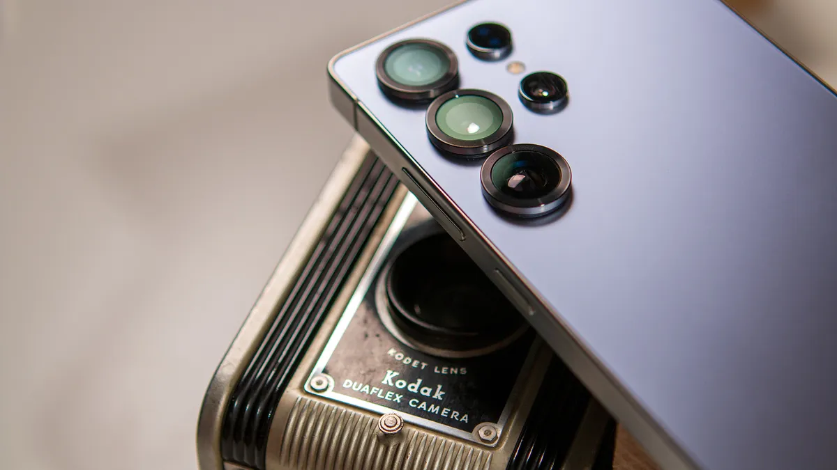 Samsung Galaxy S25 ultra camera module lying on a vintage Kodak Duaflex camera.