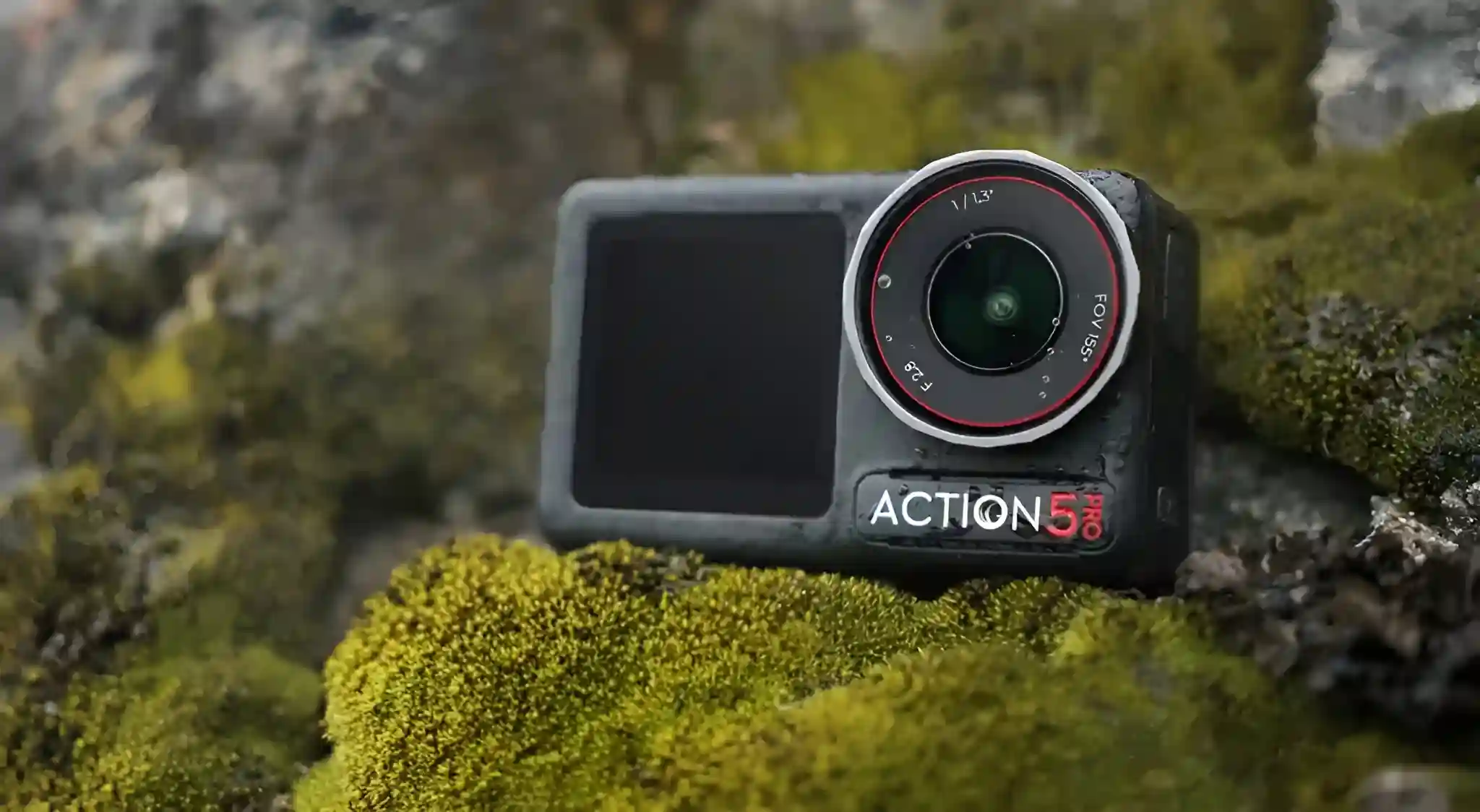 The DJI Osmo Action 5 camera, with its lens and screen visible, rests on mossy, rocky terrain.
