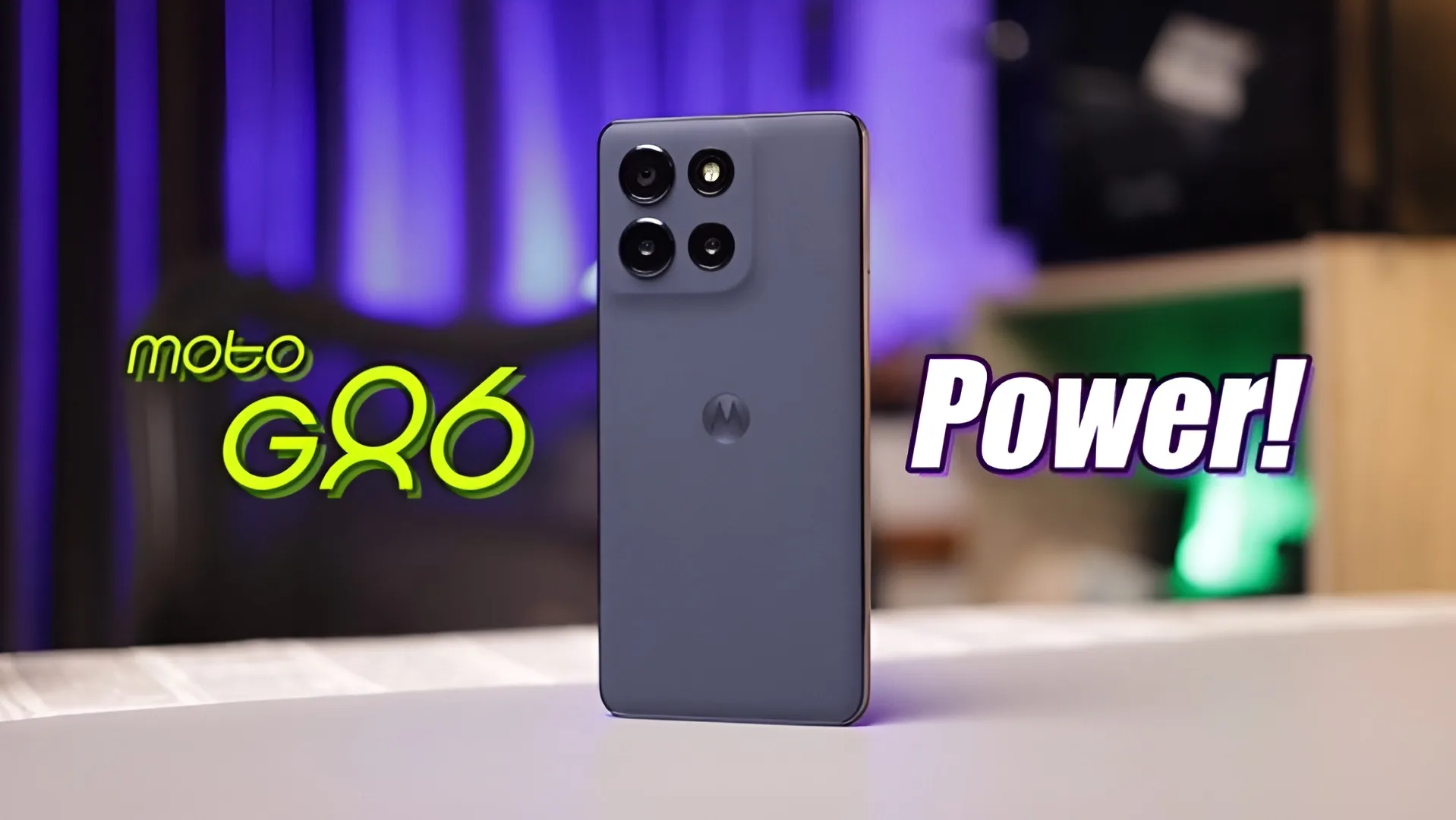The back of a grey Motorola Moto G86 5G smartphone is shown with its triple camera setup and the "moto G86" logo. The word "Power!" is written on the right side.