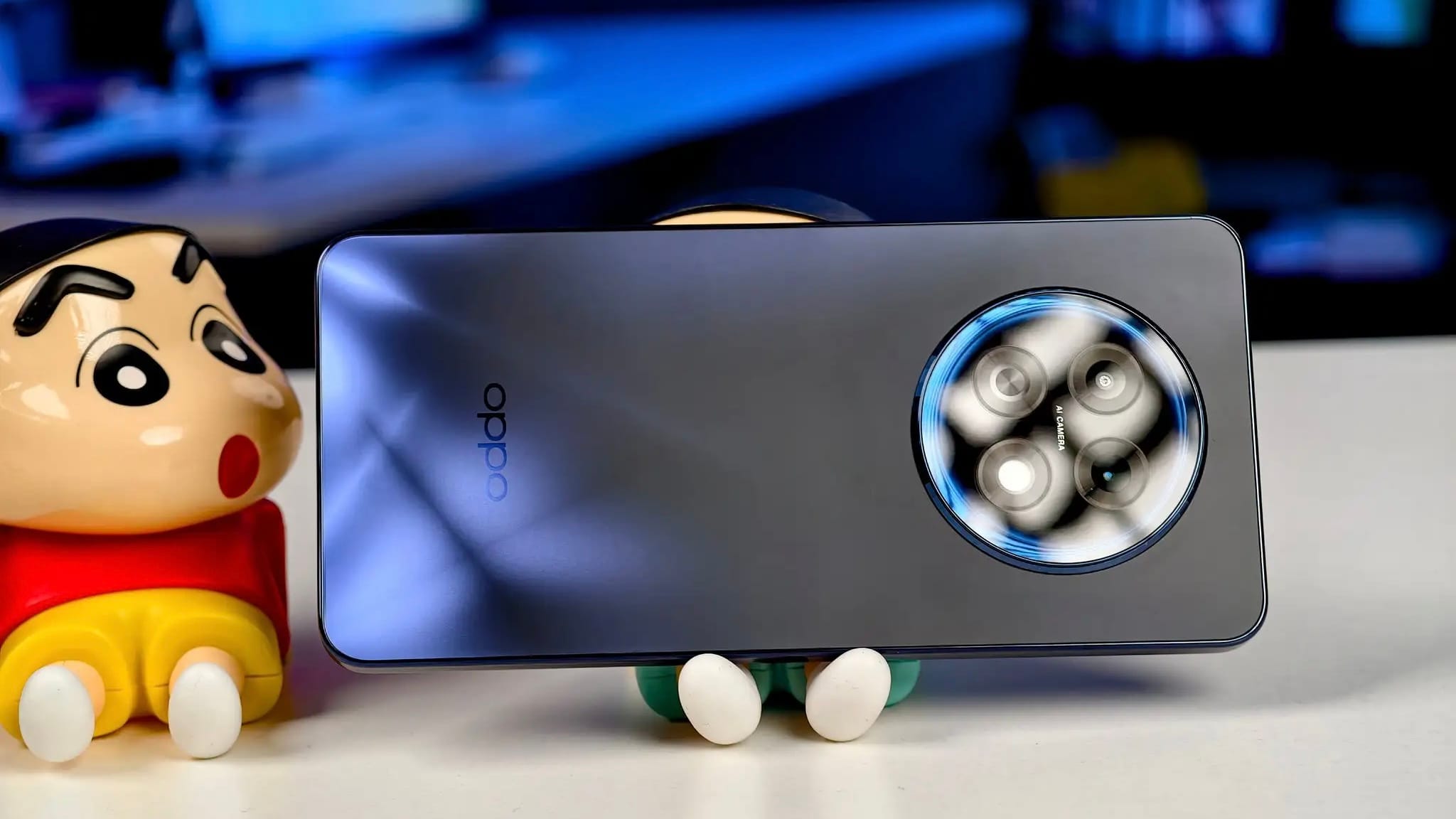 Oppo F31 pro plus 5G smartphone in blue with circular rear camera module, showcasing sleek modern design on display table.