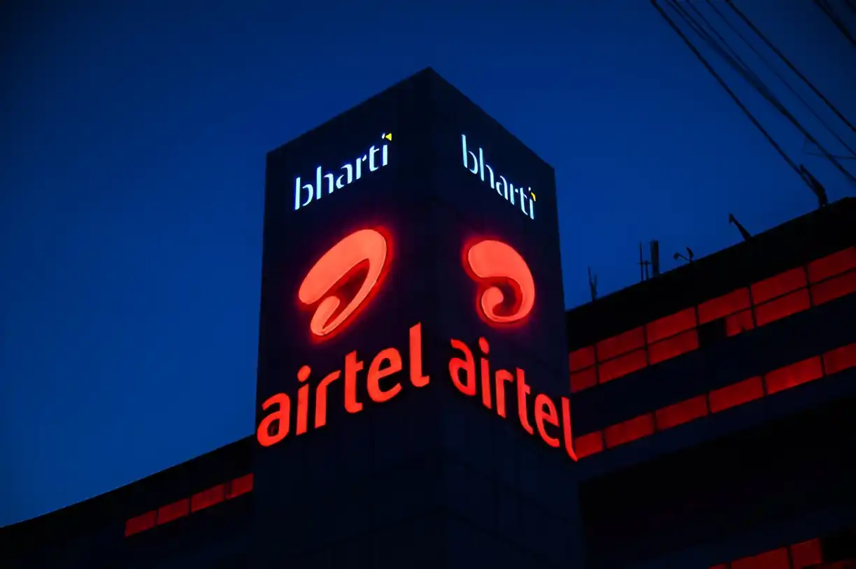 Airtel logo glowing on Bharti building at night.