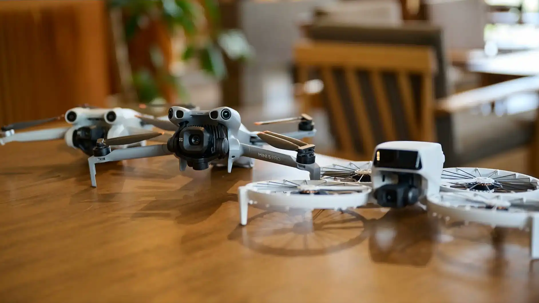 DJI Mini 5 Pro drone with 50MP camera and compact design displayed on a wooden table