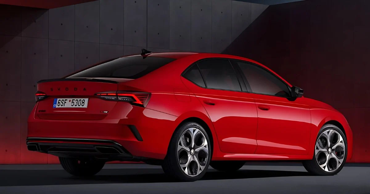Rear three-quarter view of the red 2025 Škoda Octavia RS showcasing the boot spoiler and wheels.